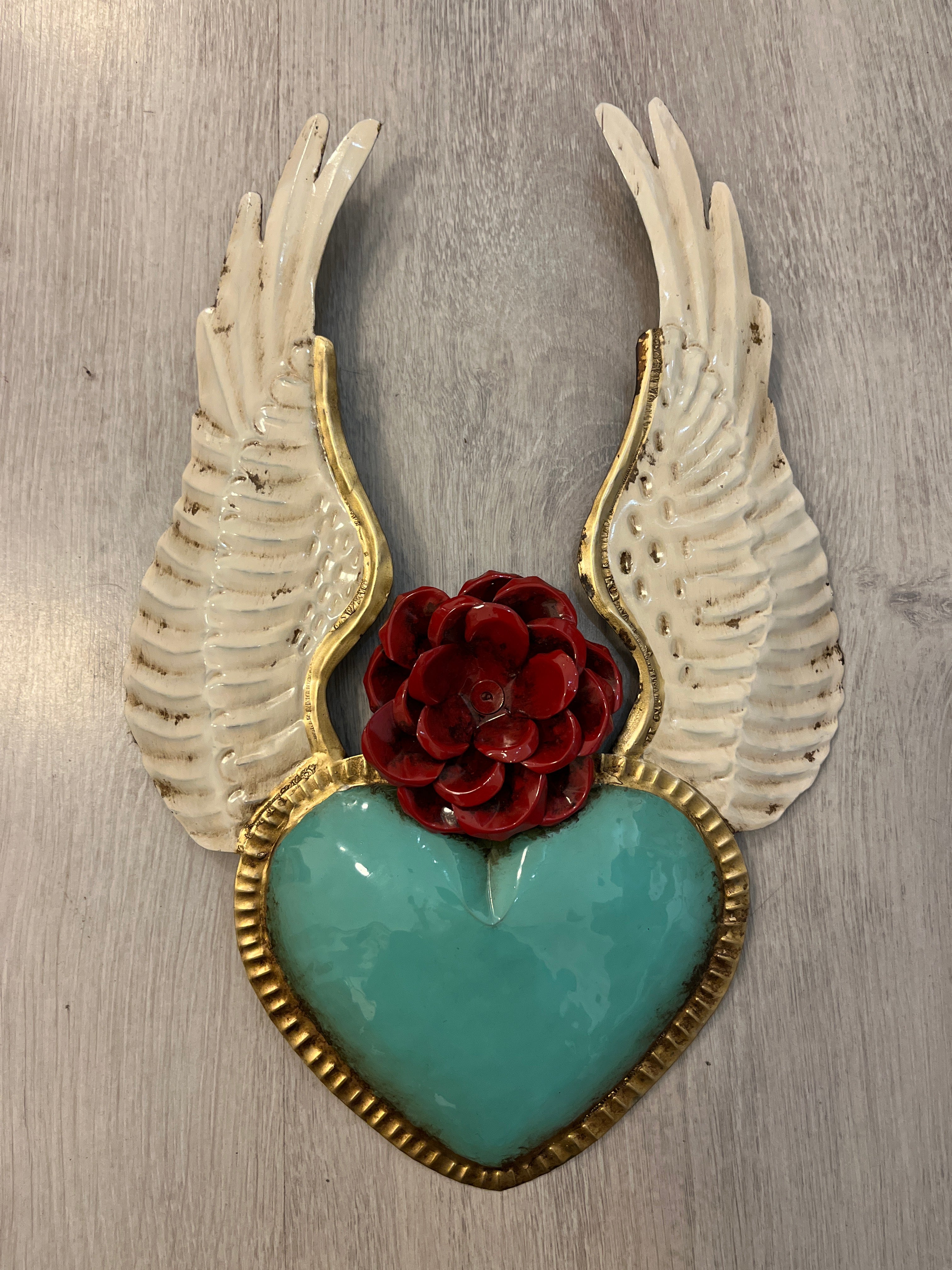 Winged heart with a flower