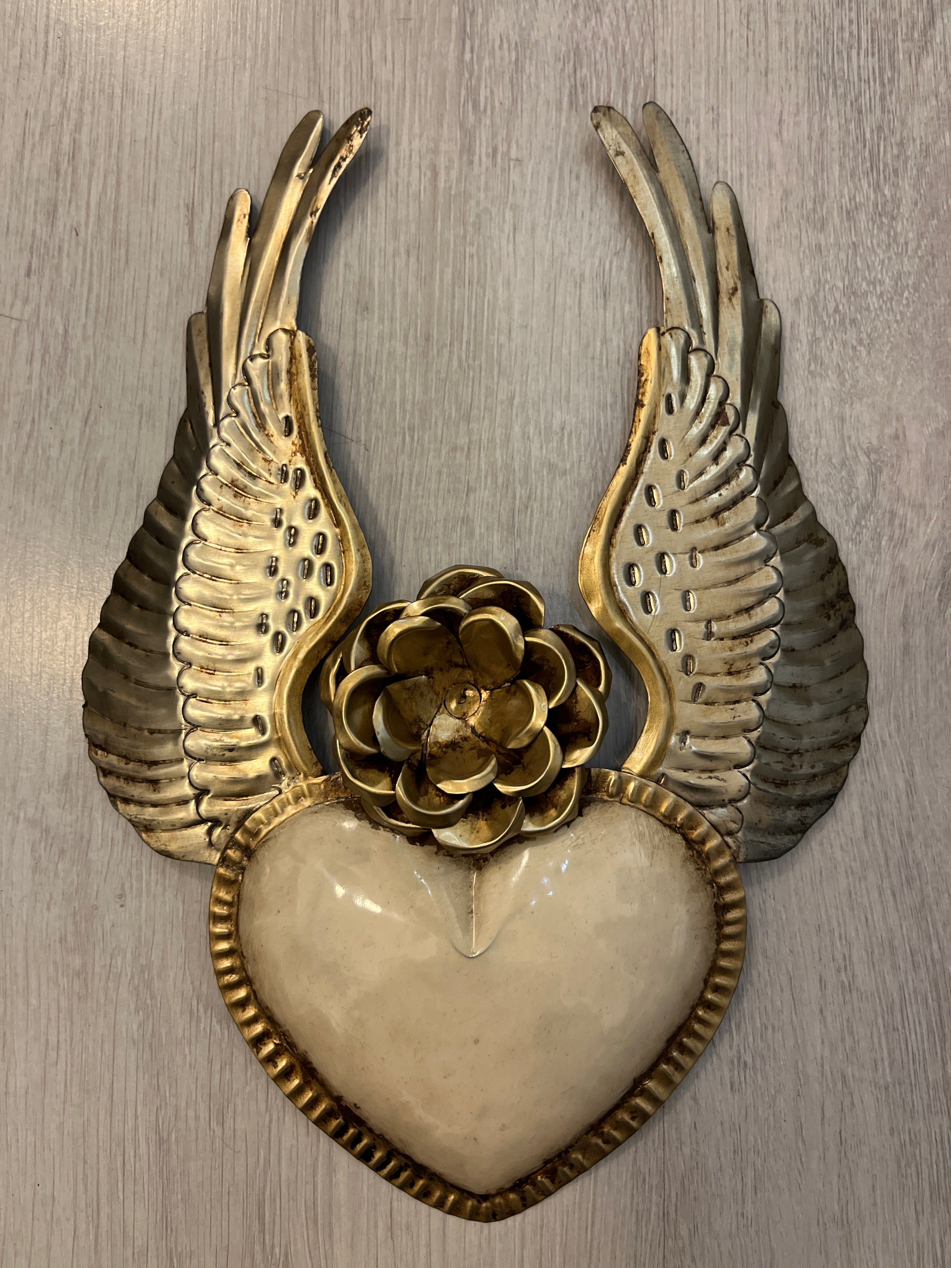 Winged heart with a flower
