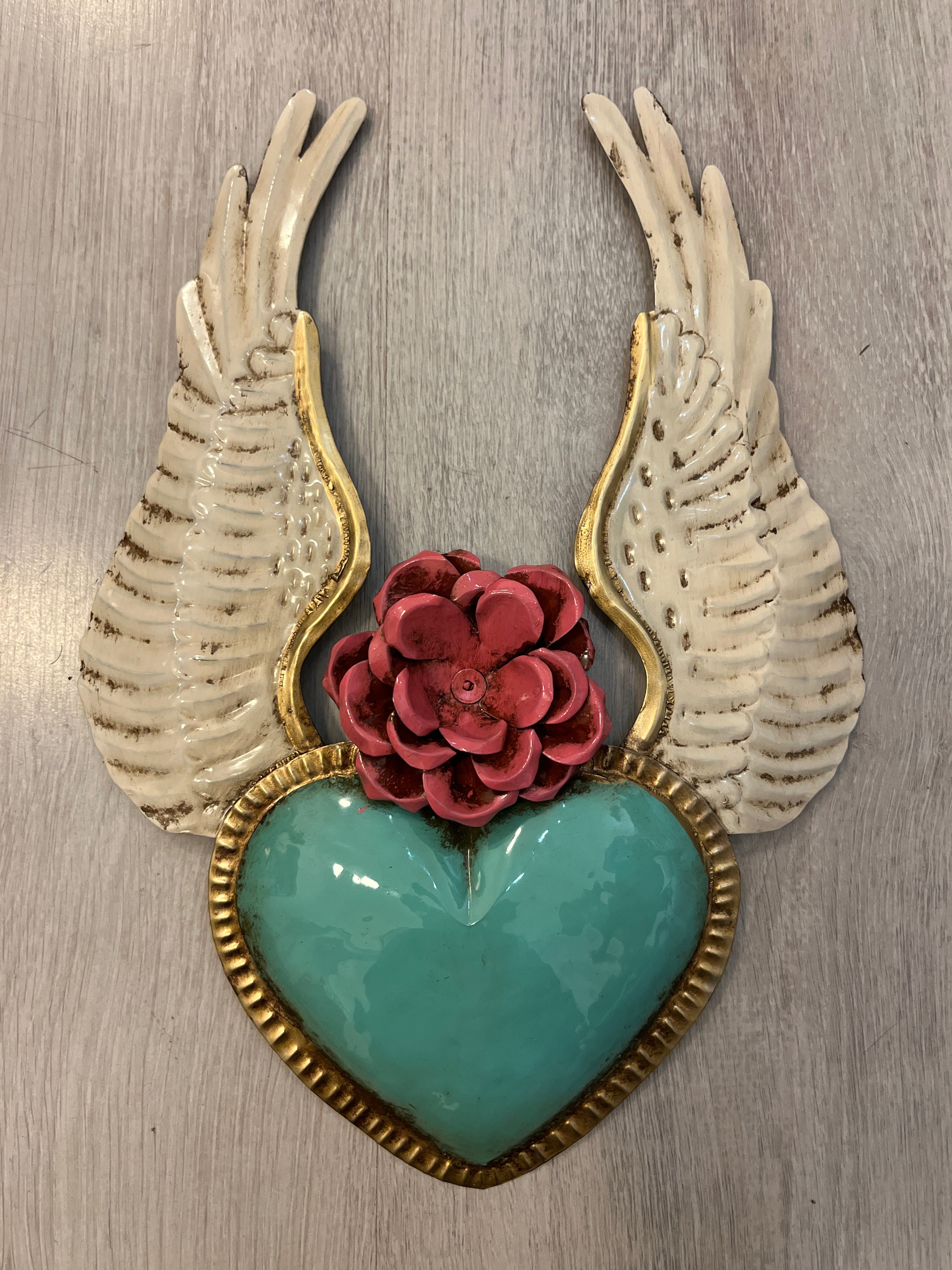Winged heart with a flower