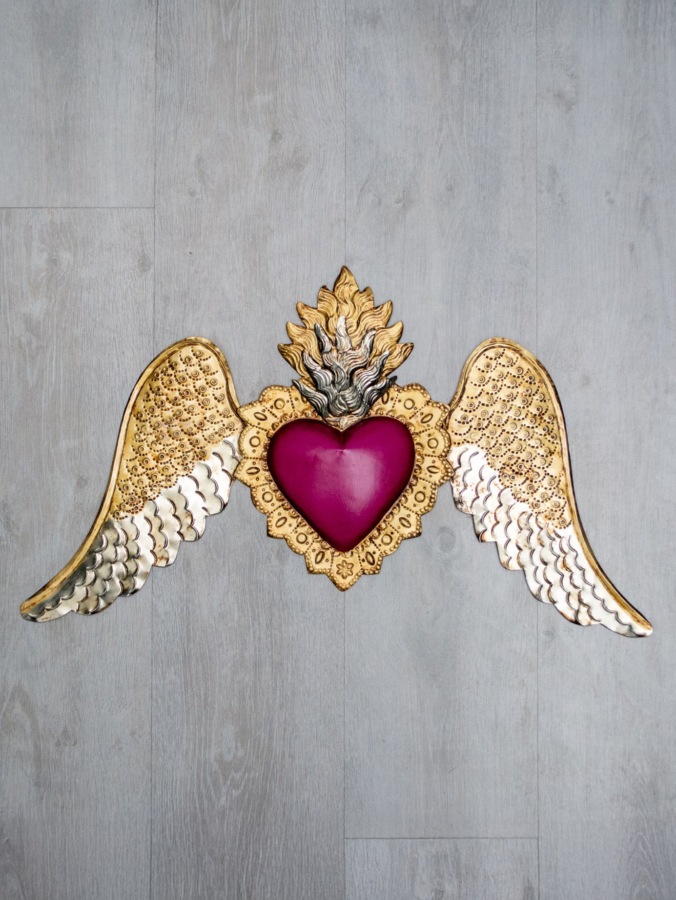Winged heart below double flame