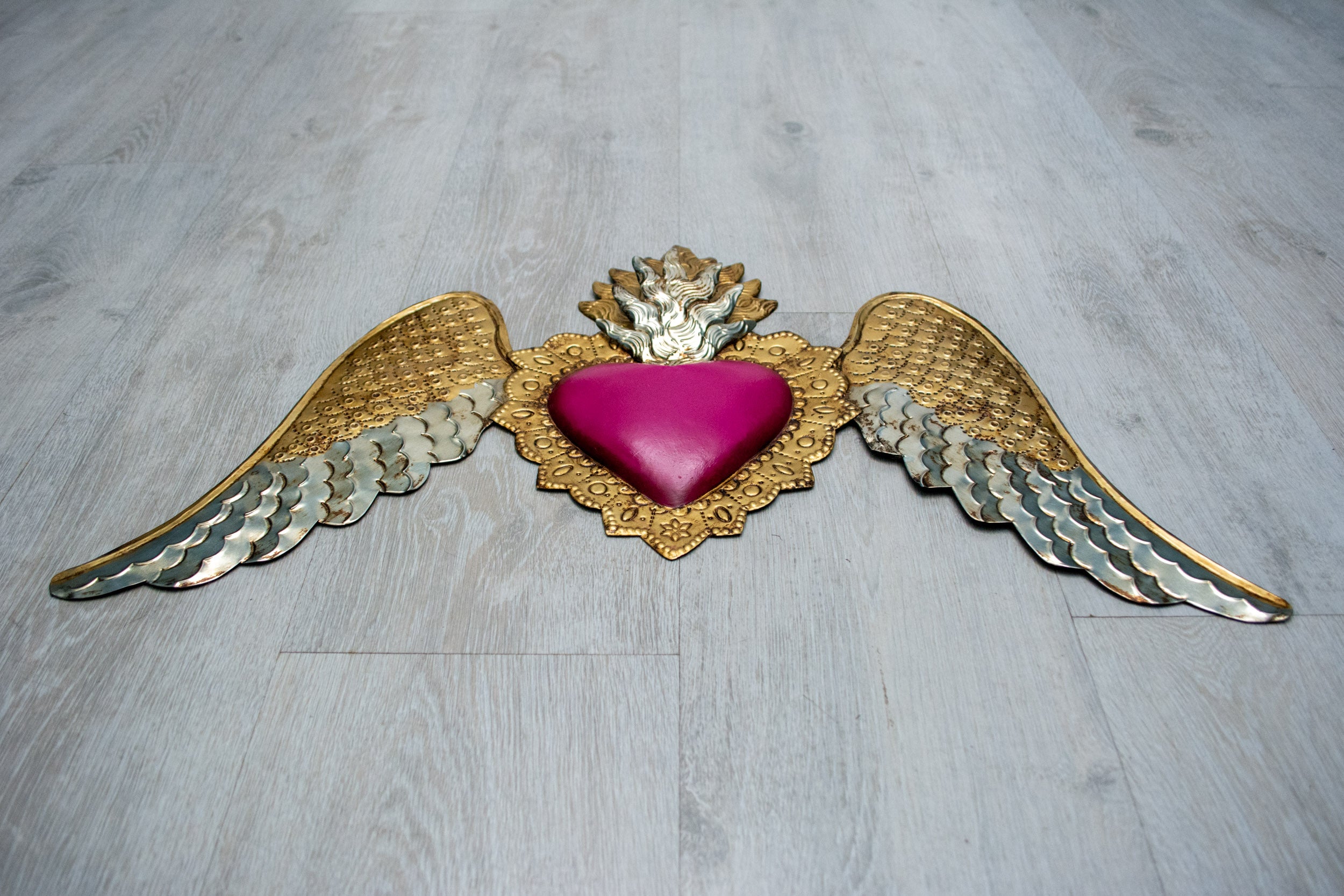 Winged heart below double flame