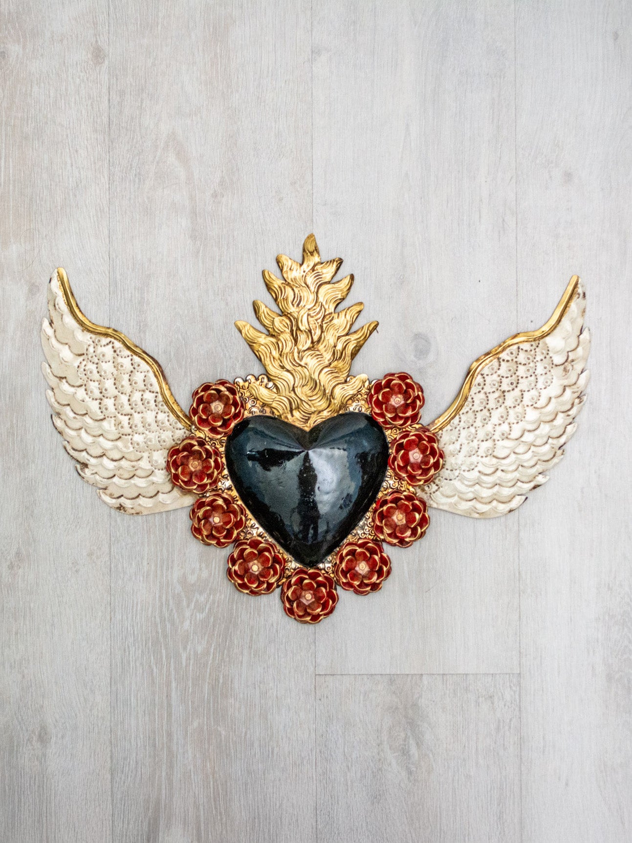 Double flame winged heart above flowers