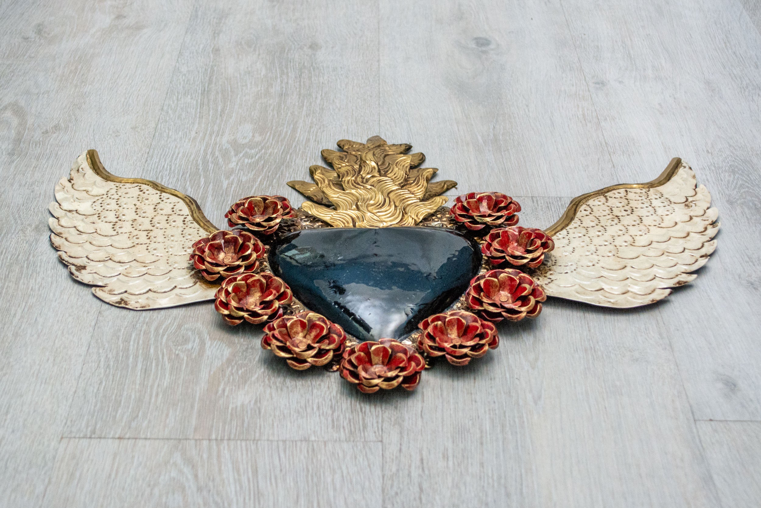 Double flame winged heart above flowers