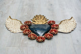 Double flame winged heart above flowers