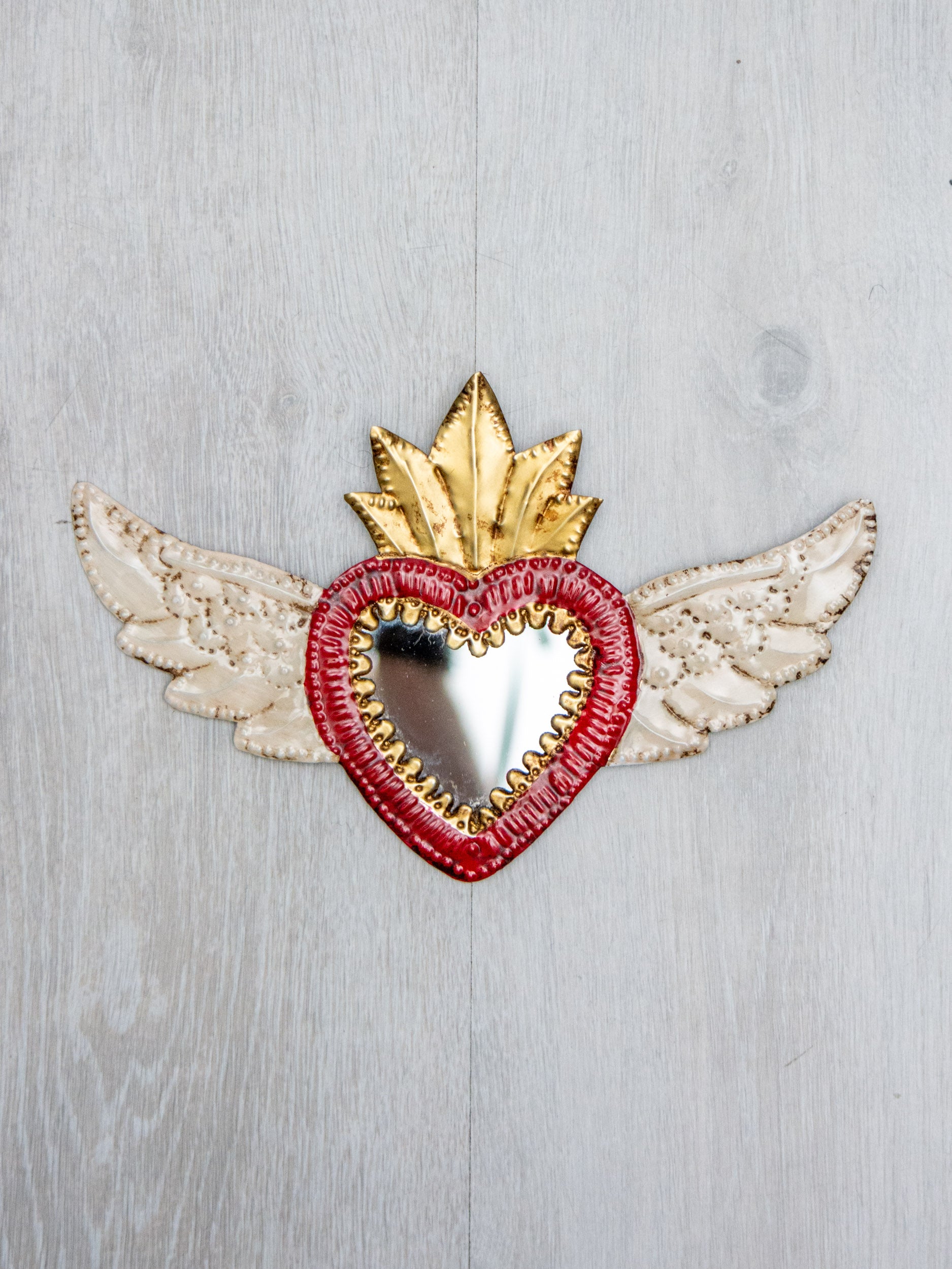 Winged heart with small mirror