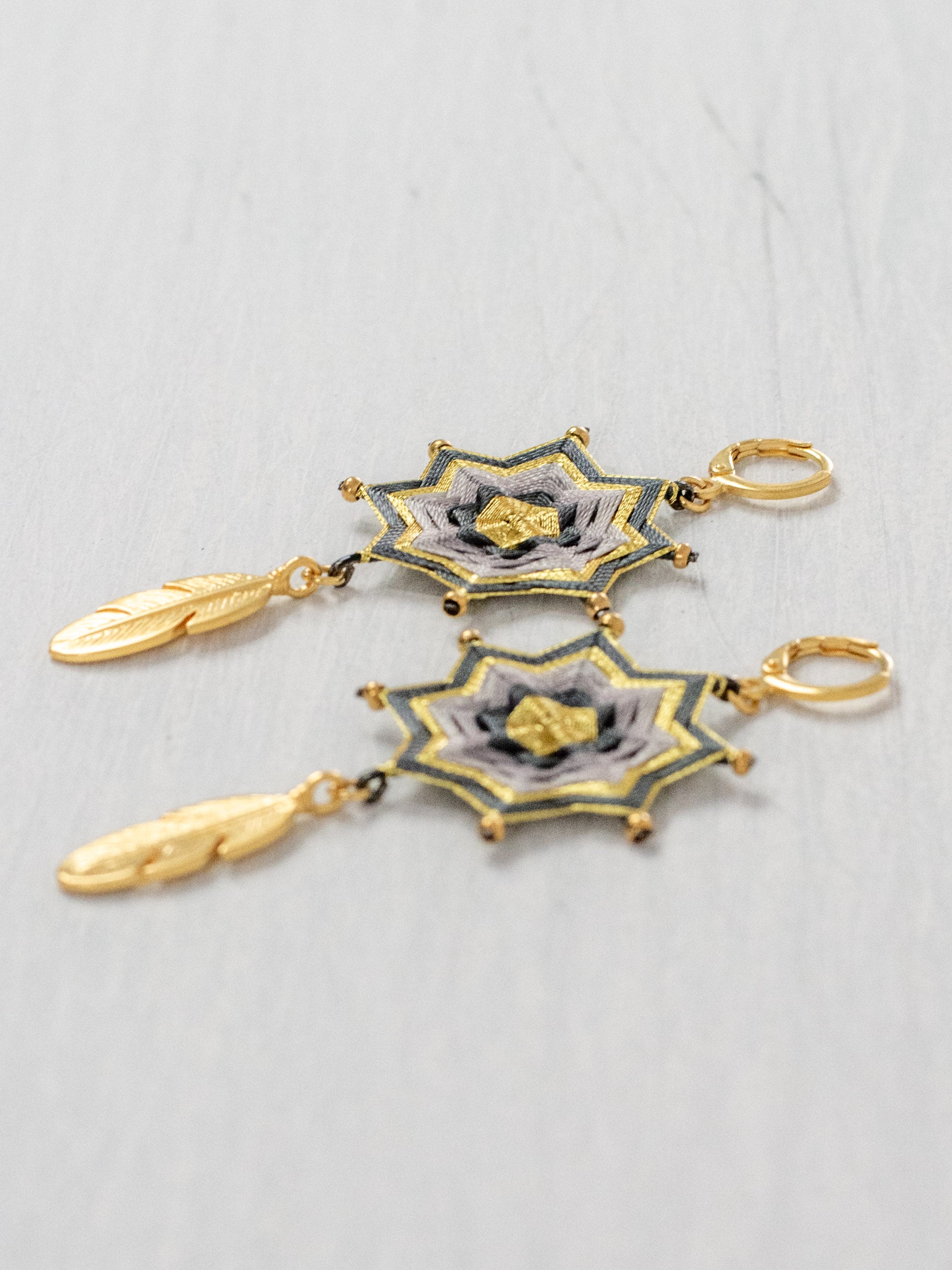 Small star mandala earrings with feathers