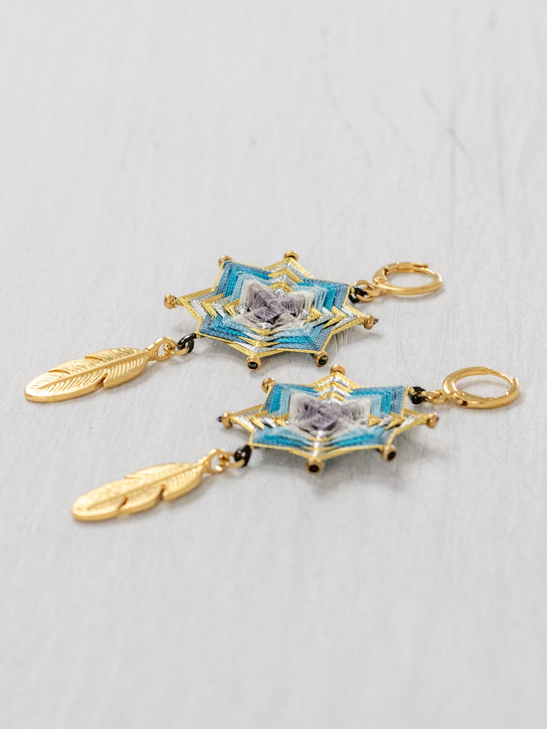 Small star mandala earrings with feathers