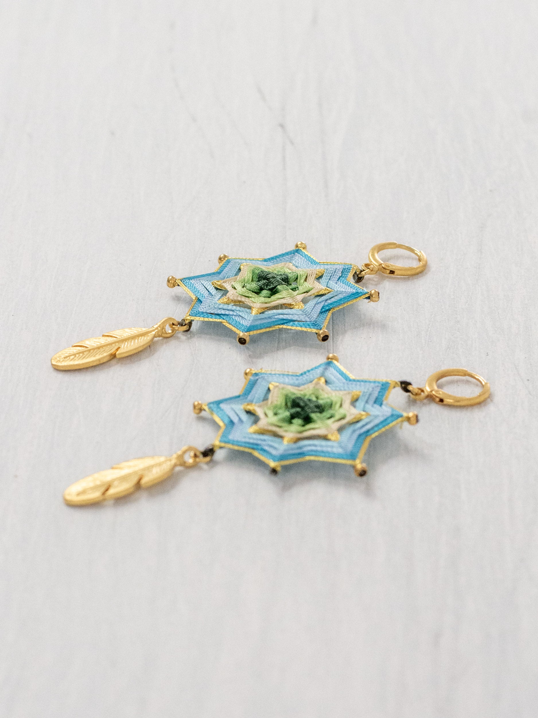 Mandala star earrings with large feathers